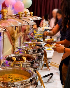 Chafing dishes with Lilly's catering spread at an event